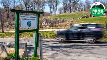 A car drives past the entrance and points to Cobbs Creek Golf Course in West Philadelphia.
