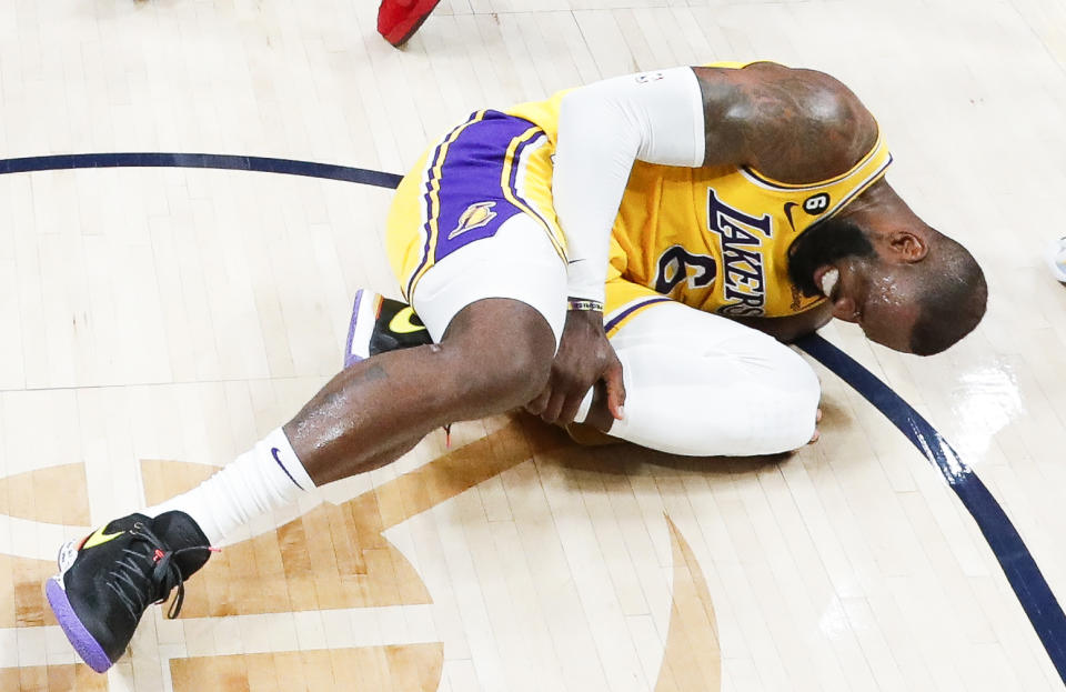 Los Angeles Lakers forward LeBron James on the field after injuring his leg during the second half of Game 2 in the Western Conference Finals against the Denver Nuggets at Ball Arena in Denver on May 18, 2023. (Photos)