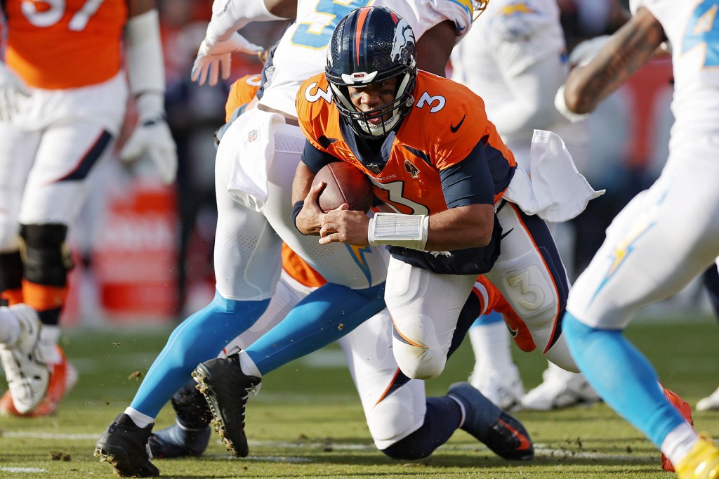 Russell Wilson #3 of the Denver Broncos runs the ball during the first quarter against the Los Angeles Chargers at Empower Field At Mile High on January 08, 2023 in Denver, Colorado. 
