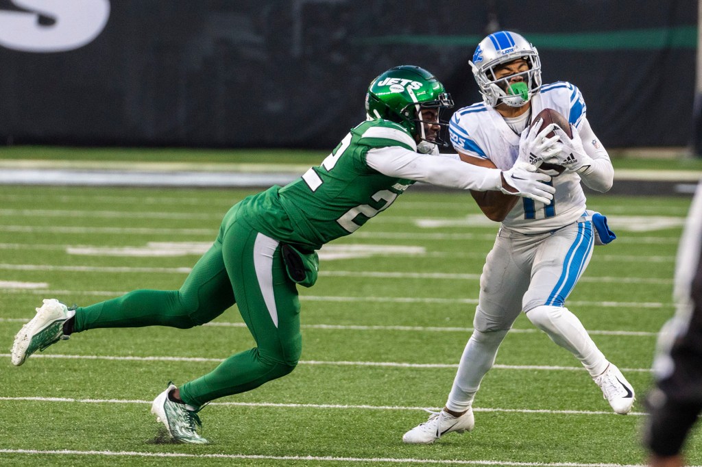 Tony Adams #22 of the New York Jets tackles Kalif Raymond #11 of the Detroit Lions in the second half at MetLife Stadium, Sunday, Dec. 18, 2022, in East Rutherford, NJ. 