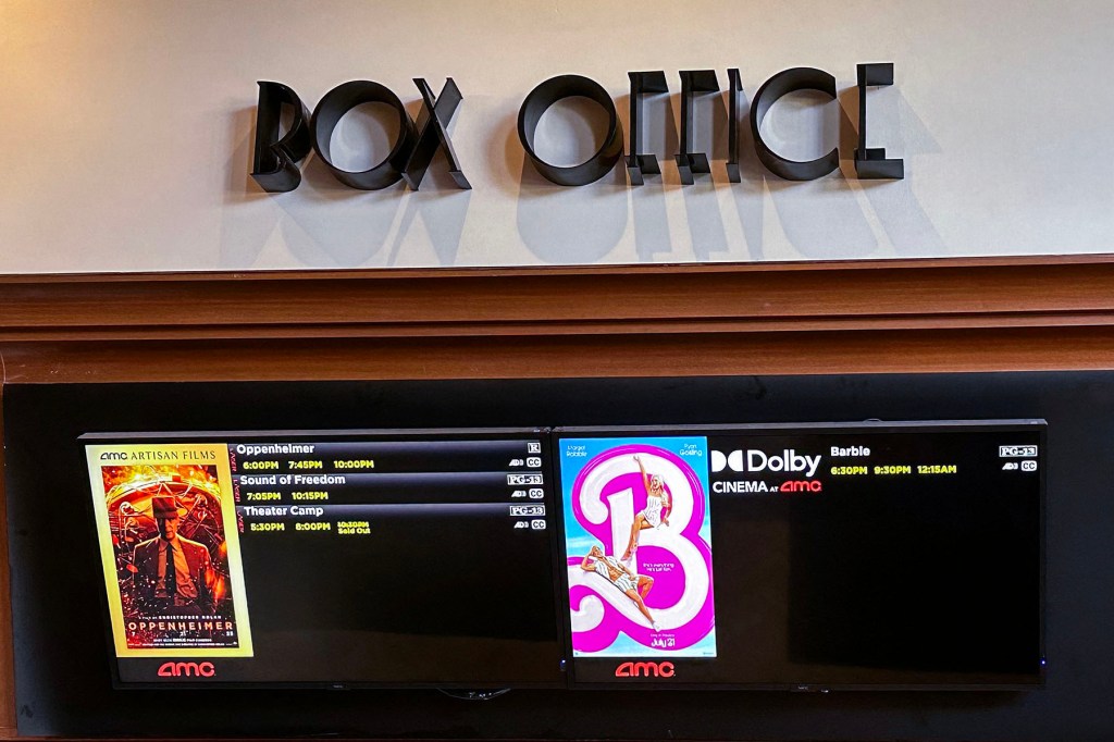 A movie theater box office is pictured announcing the opening of "Oppenheimer" and "Barbie" movies.