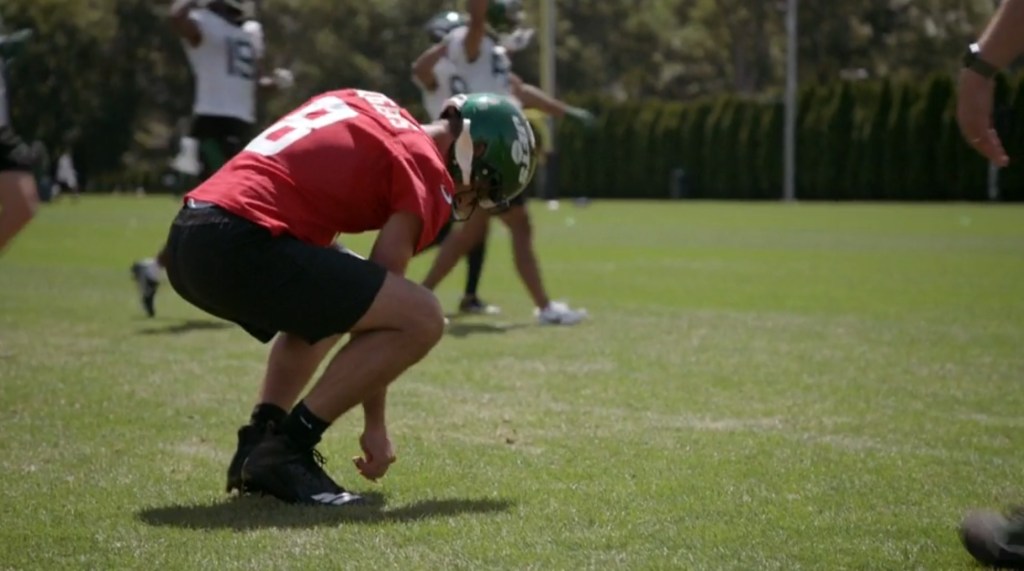Aaron Rodgers was having fun with the grass at camp.