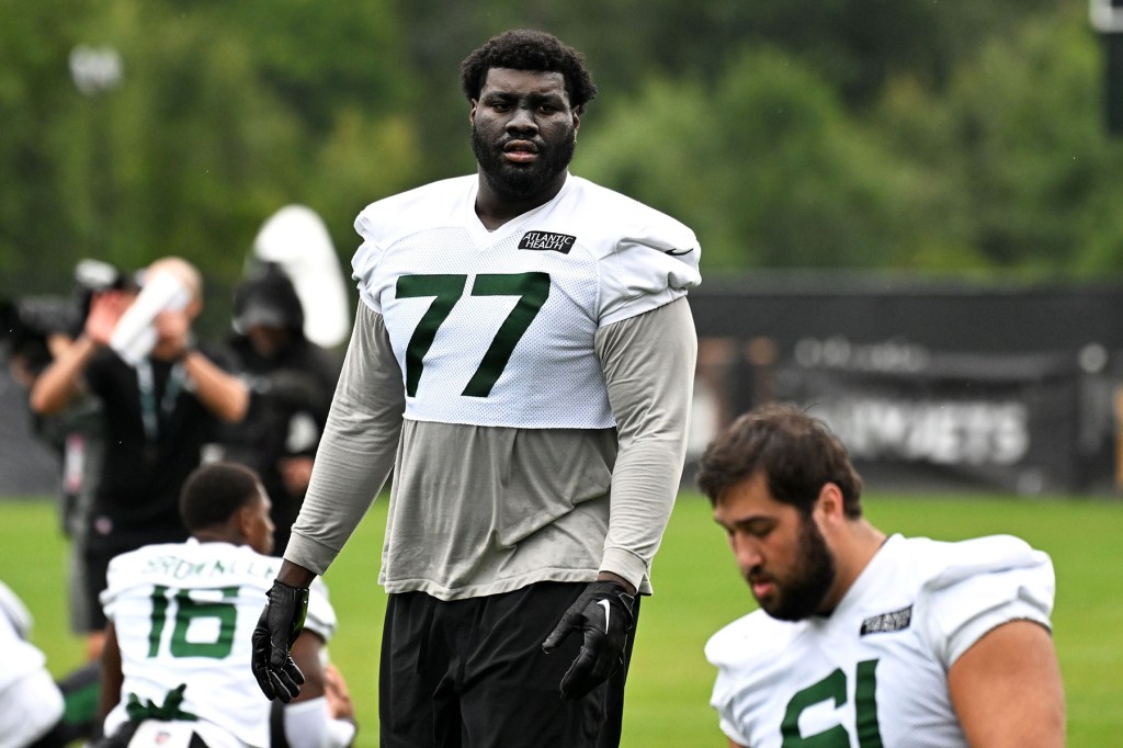 Jets offensive tackle Mekhi Becton (77) stretches during practice at training camp in Florham Park, NJ. 