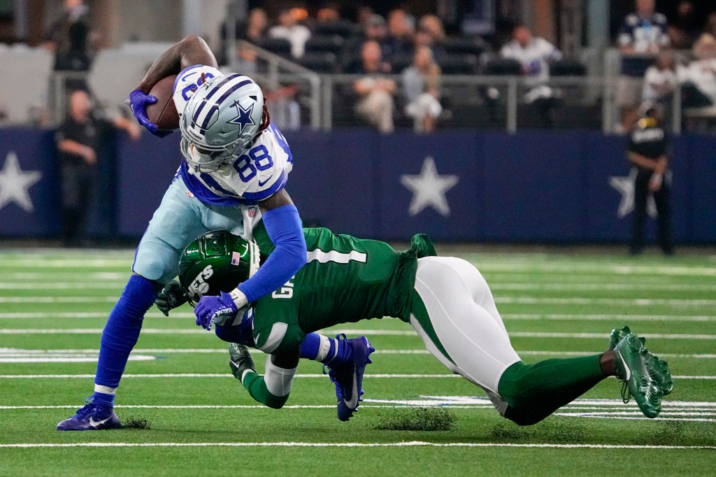 Sauce Gardner tackles CeeDee Lamb in the Jets' loss to the Cowboys.