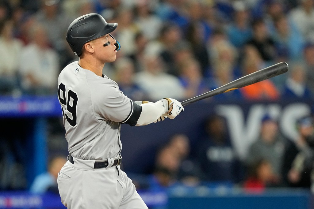 The Yankees' Aaron Judge hits a home run against the Blue Jays.