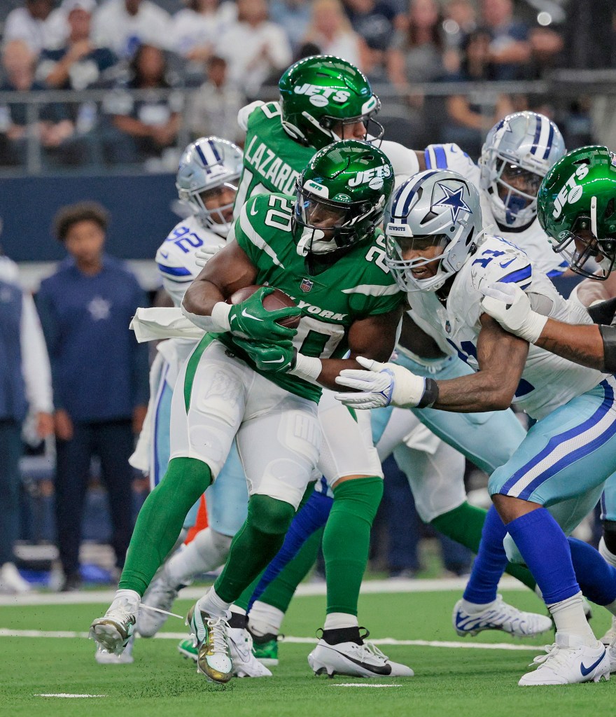 Breece Hall of the Jets is tackled by the Cowboys' Micah Parsons.