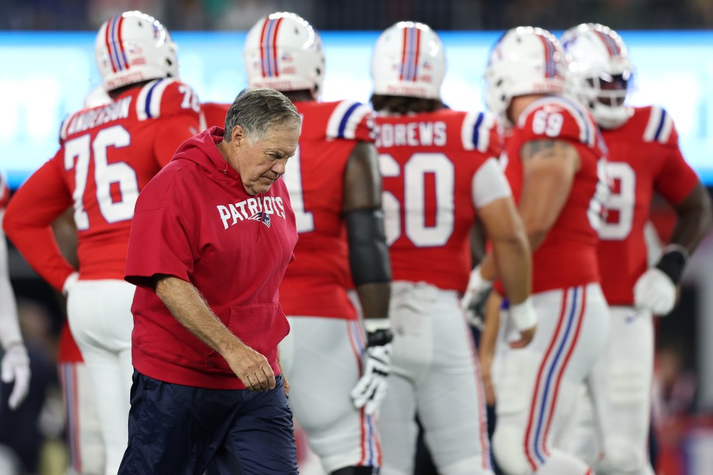 Bill Belichick paces the field before the Patriots play the Dolphins.