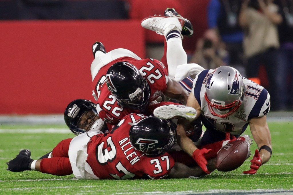 New England Patriots' Julian Edelman makes a catch as Atlanta Falcons' Ricardo Allen and Keanu Neal defend, during the second half of the NFL Super Bowl 51 football game on Feb. 5, 2017, in Houston.