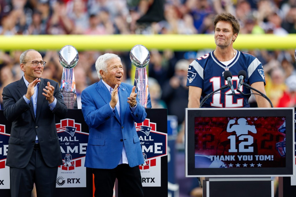 New England Patriots president Jonathan Kraft and chairman and CEO Robert Kraft congratulate former quarterback Tom Brady during the halftime ceremony of an NFL football game against the Philadelphia Eagles, Sunday, Sept. 10, 2023.