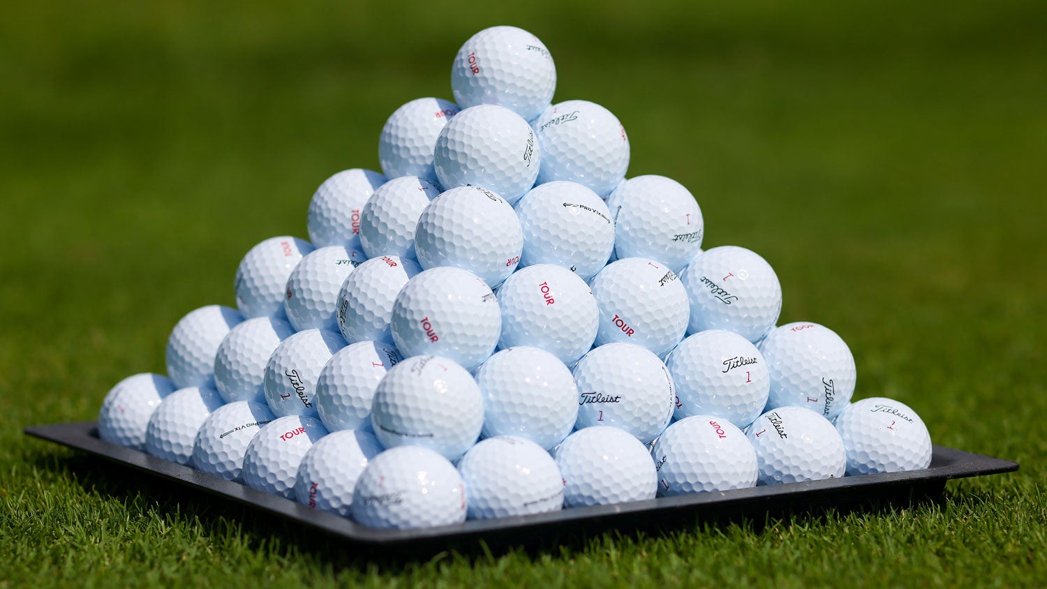 pyramid of golf balls on driving range