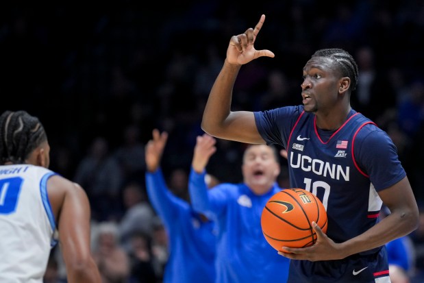 UConn guard Hassan Diarra (10) signals to teammates during an NCAA college basketball game against Xavier, Wednesday, Jan. 10, 2024, in Cincinnati. (AP Photo/Aaron Doster)