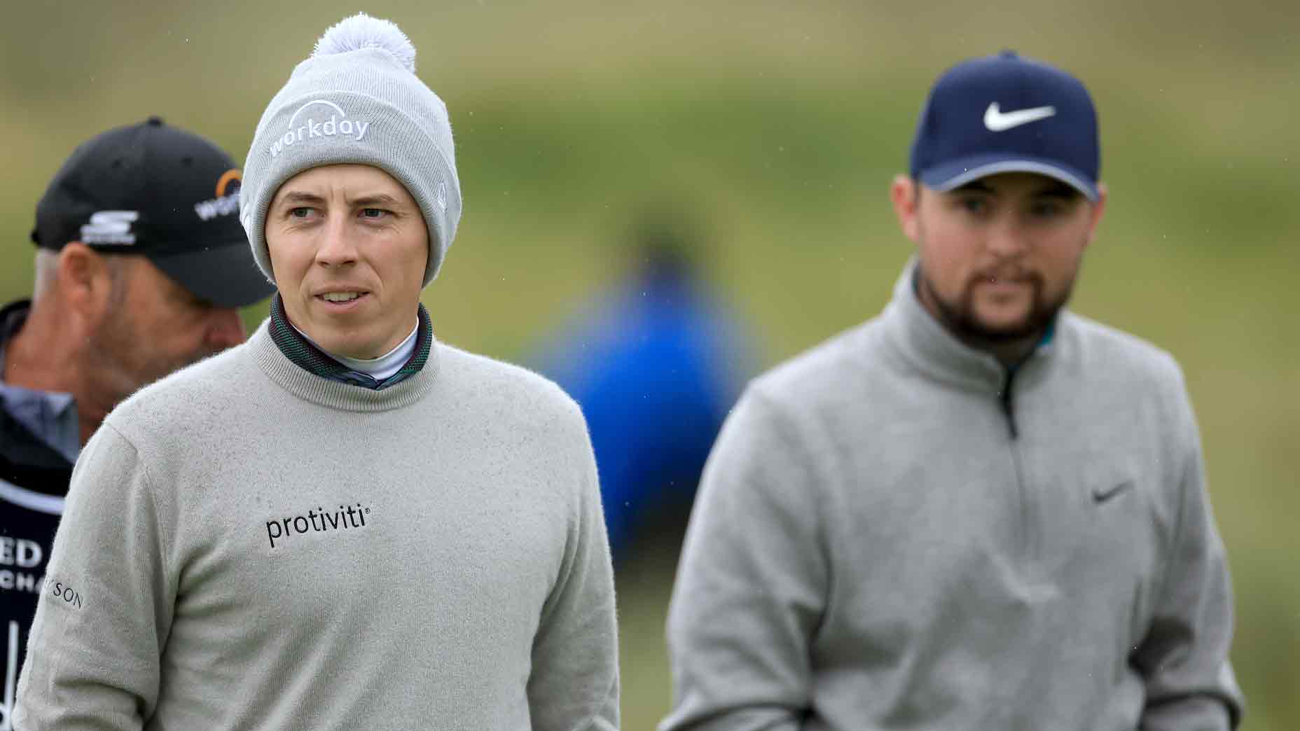 Matthew Fitzpatrick (L) and Alex Fitzpatrick of England leave the tee on the sixth hole during the first round of the Alfred Dunhill Links Championship on the Championship Links at Carnoustie on October 05, 2023 in St Andrews, Scotland.