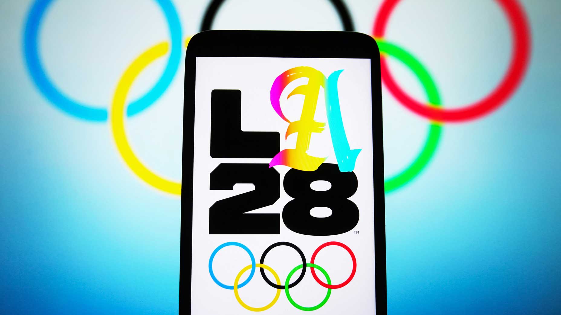 An artistic rendering of the 2028 LA Olympics logo on a smartphone